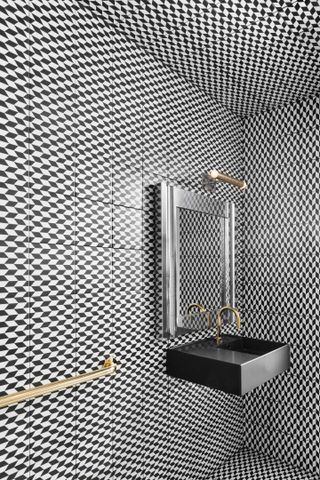 A small bathroom with 3D style black tiles
