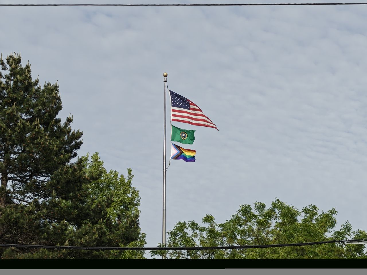 Three flags on a flag pole
