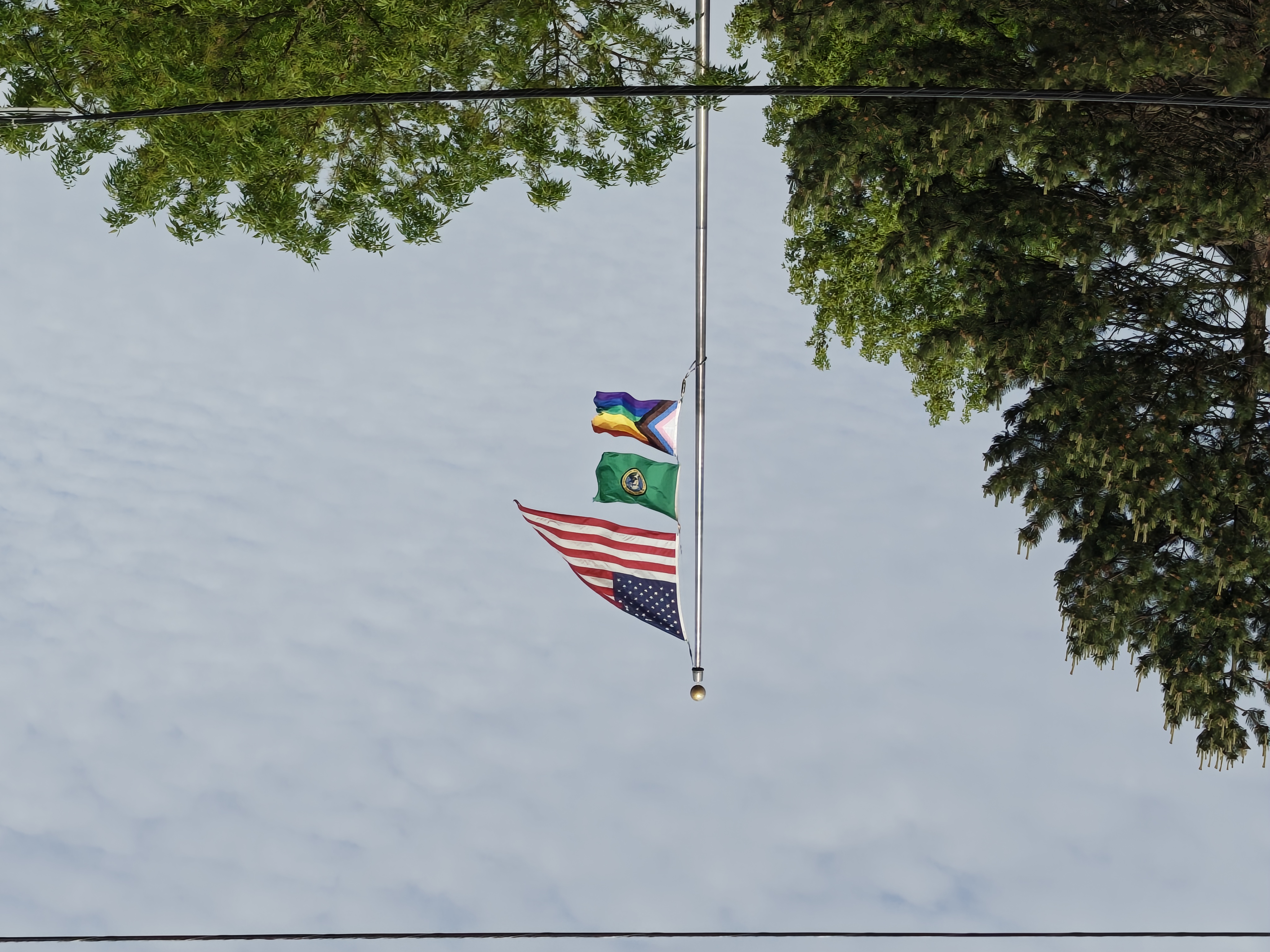 Three flags on a flag pole
