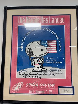 The 1995 "Around the Moon and Home Again" Snoopy poster was created for a Charles Schulz art exhibit at Space Center Houston, the Johnson Space Center visitor center.