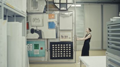 Staff member at one of Switzerland's art museums pulls out a rack of stored paintings
