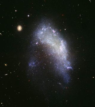 Hubble Sees Galaxy on Verge of Destruction