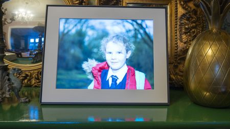 Aura Walden photo frame on sideboard with various household objects