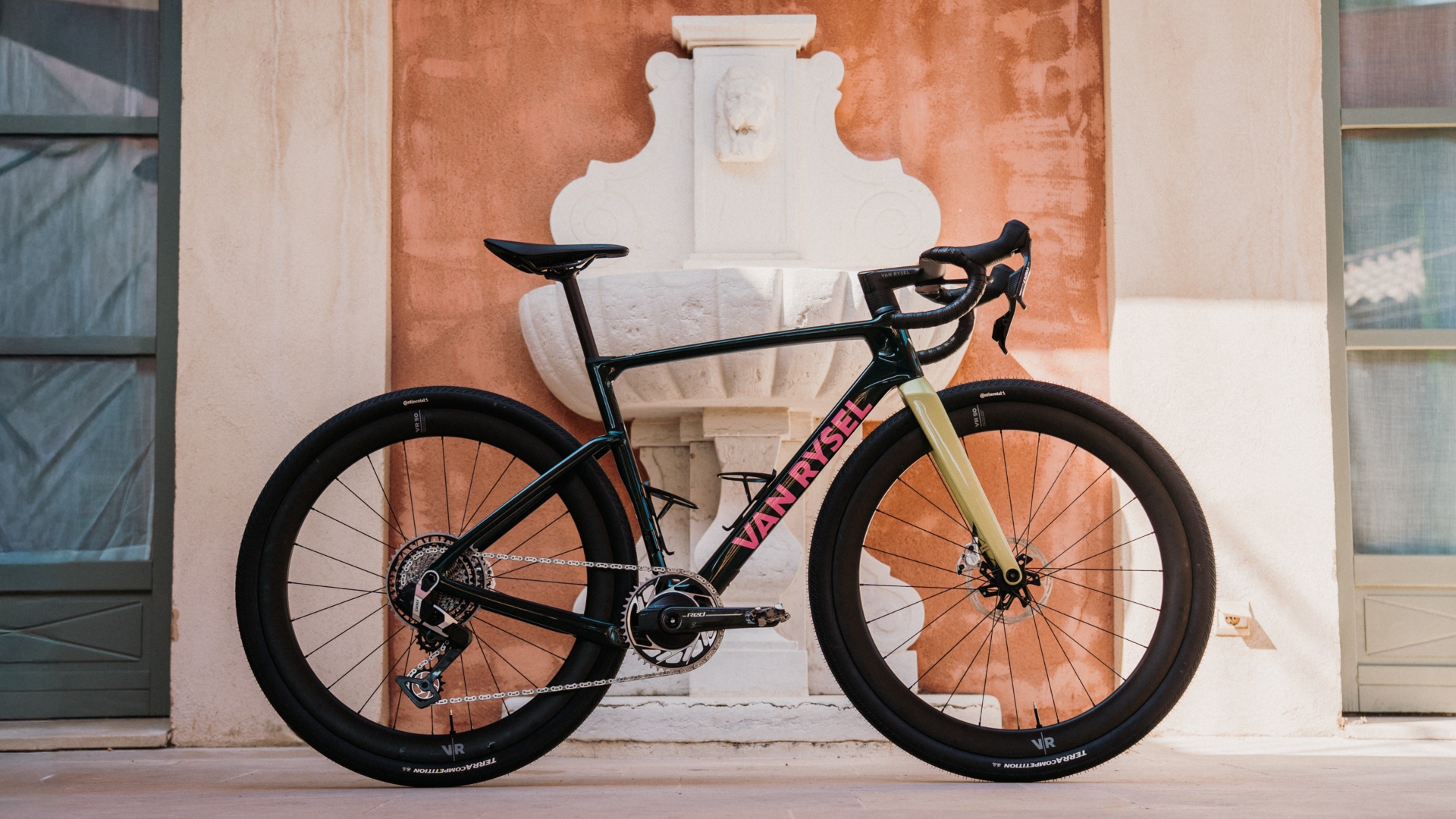 The all new Van Rysel RCR-G gravel bike leaning up against a white ornate fountain