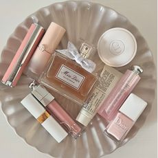 A white tray with beauty products including the Miss Dior perfume