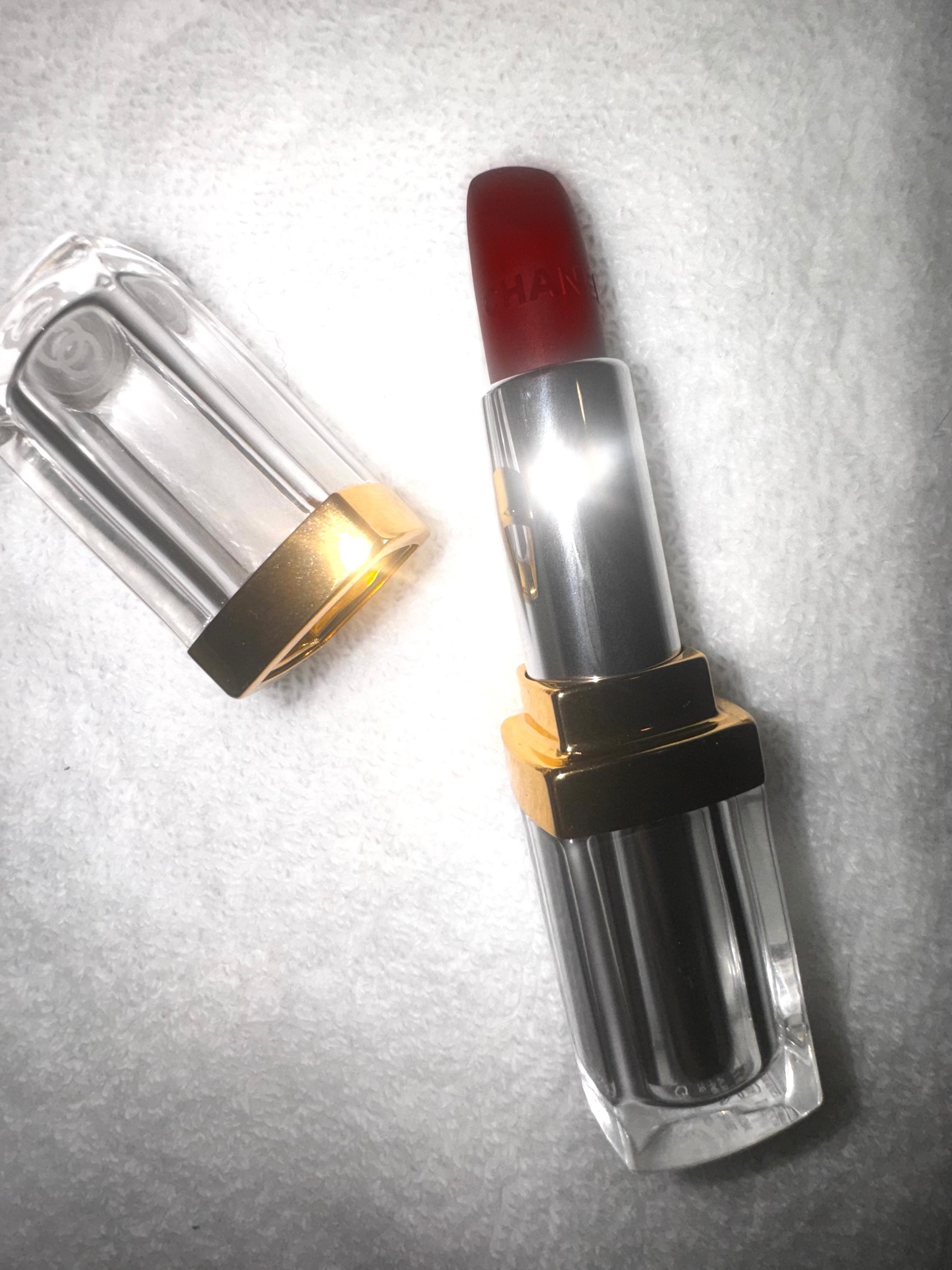An open tube of red Chanel lipstick.
