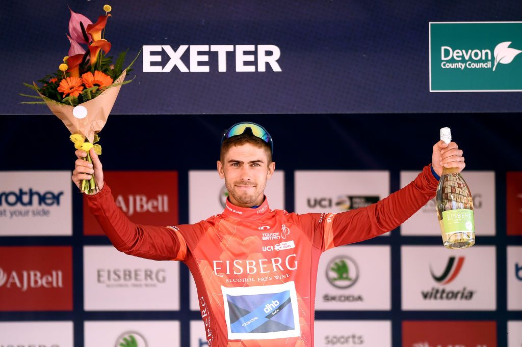 EXETER ENGLAND SEPTEMBER 06 Jacob Scott of United Kingdom and Team Canyon DHB Sungod celebrates winning the red sprint jersey on the podium ceremony after the 17th Tour of Britain 2021 Stage 2 a 1839km stage from Sherford to Exeter TourofBritain TourofBritain on September 06 2021 in Exeter England Photo by Harry TrumpGetty Images