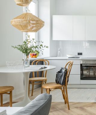 Scandinavian-style apartment with small dining area and oven in kitchen