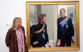 Artist Nicky Phillips stands beside a double portrait she painted of Prince William and Prince Harry which was unveiled at the National Portrait Gallery on January 6, 2010 in London, England.
