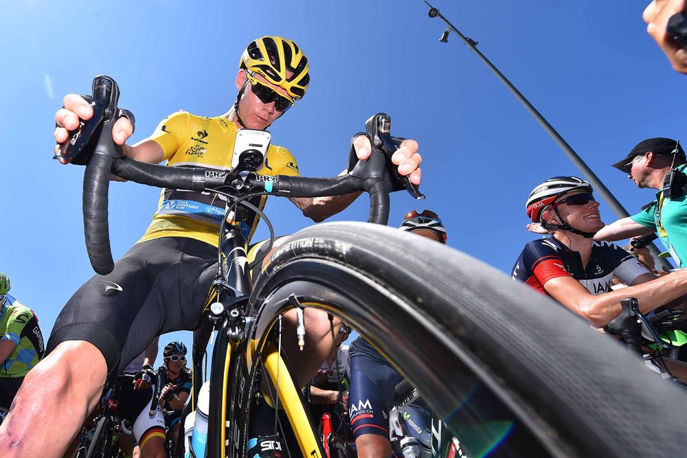 Chris Froome (Team Sky) checks his bike