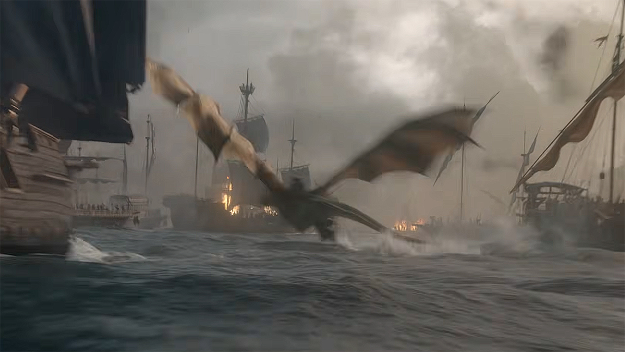A dragon flying just above the ocean as ships burn around it in House of the Dragon season 3