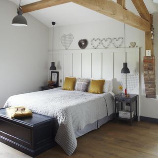 light green bedroom with pendant lights above the bed