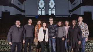 Simon Askey, Evan Hancock, Joy Dando, Rhiannon Chard, Gareth Malone, Samar Small, Annette Leponis, Astrid Glover and Jake Sawyers stand together in a singing space in Gareth Malone's Easter Passion.