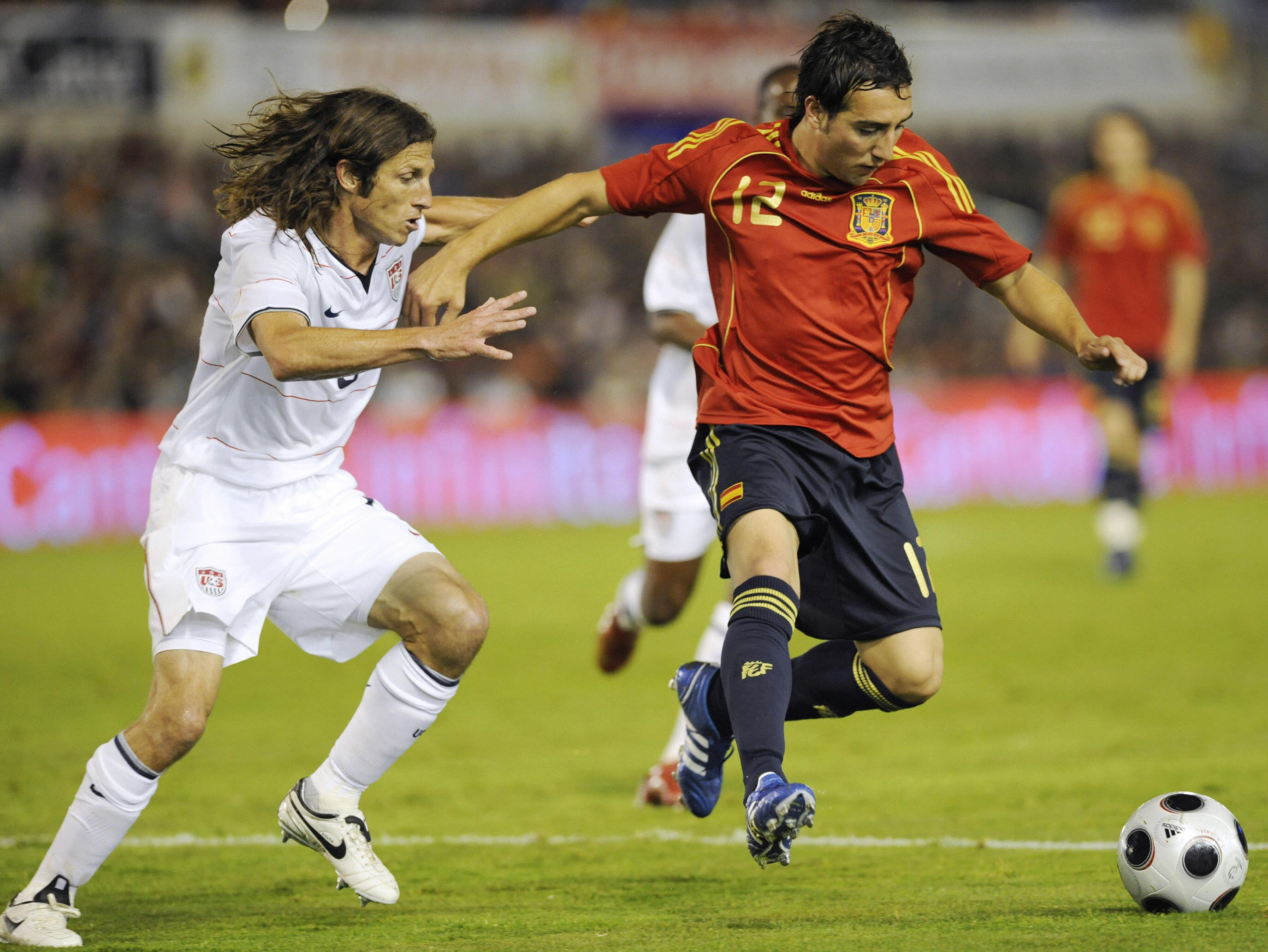 Spain's Santi Cazorla holds off a United States player in a friendly in 2010.