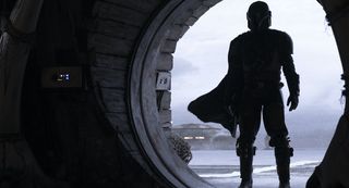 The Mandalorian standing in silhouette
