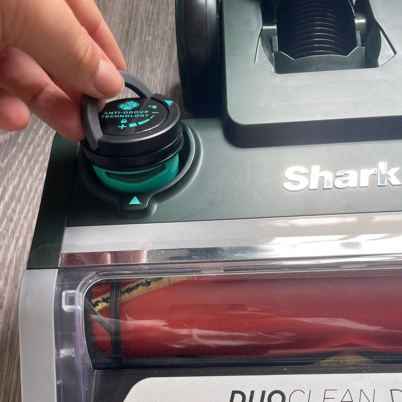 Hand putting anti-odour cartridge into Shark PowerDetect Transformer Corded Upright Vacuum Cleaner