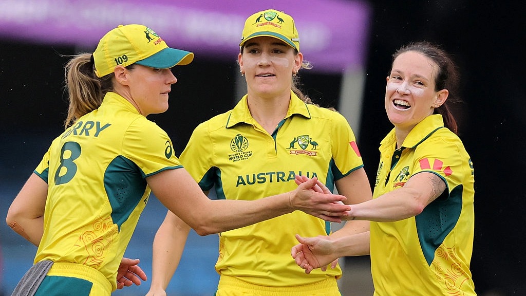 Megan Schutt of Australia celebrates with teammates Ellyse Perry and Annabel Sutherland during their victory against South Africa in the Women's Cricket World Cup