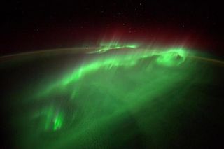 The northern lights dance over Earth in shimmering green light on Aug. 29, 2014 in this amazing photo by European Space Agency astronaut Alexander Gerst on the International Space Station. Recent solar storms on Sept. 8 and 10 may amplify Earth's northern