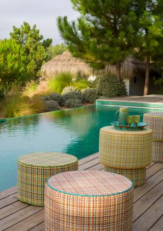 Pagopago boucle weave fabric on stools by a pool