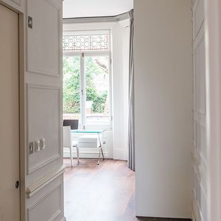 bedroom workspace with white wall window and door