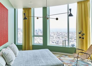 Green bedroom with yellow curtains