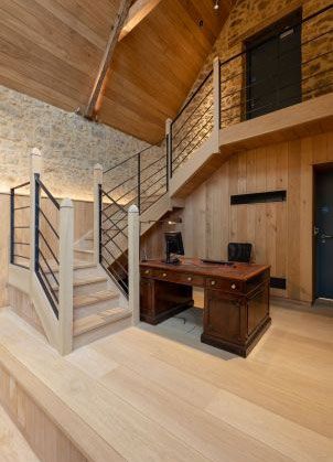 contemporary wooden staircase with desk beneath and wooden wall panelling