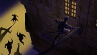 One thief climbs to a window as another is chased through the streets below
