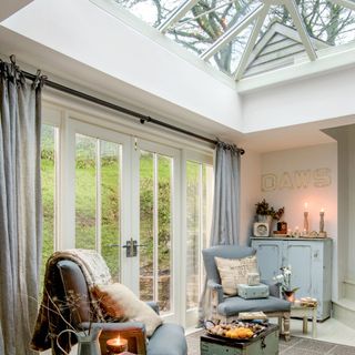 Interior of conservatory with curtains and armchairs
