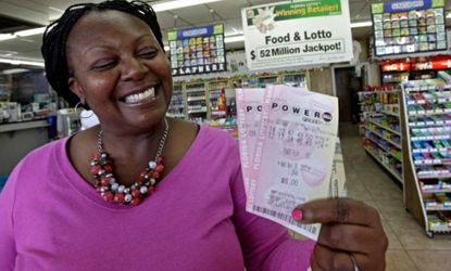 Felicia Ross flashes a winning smile in Orlando, Fla., while showing off Powerball tickets that probably won't win.