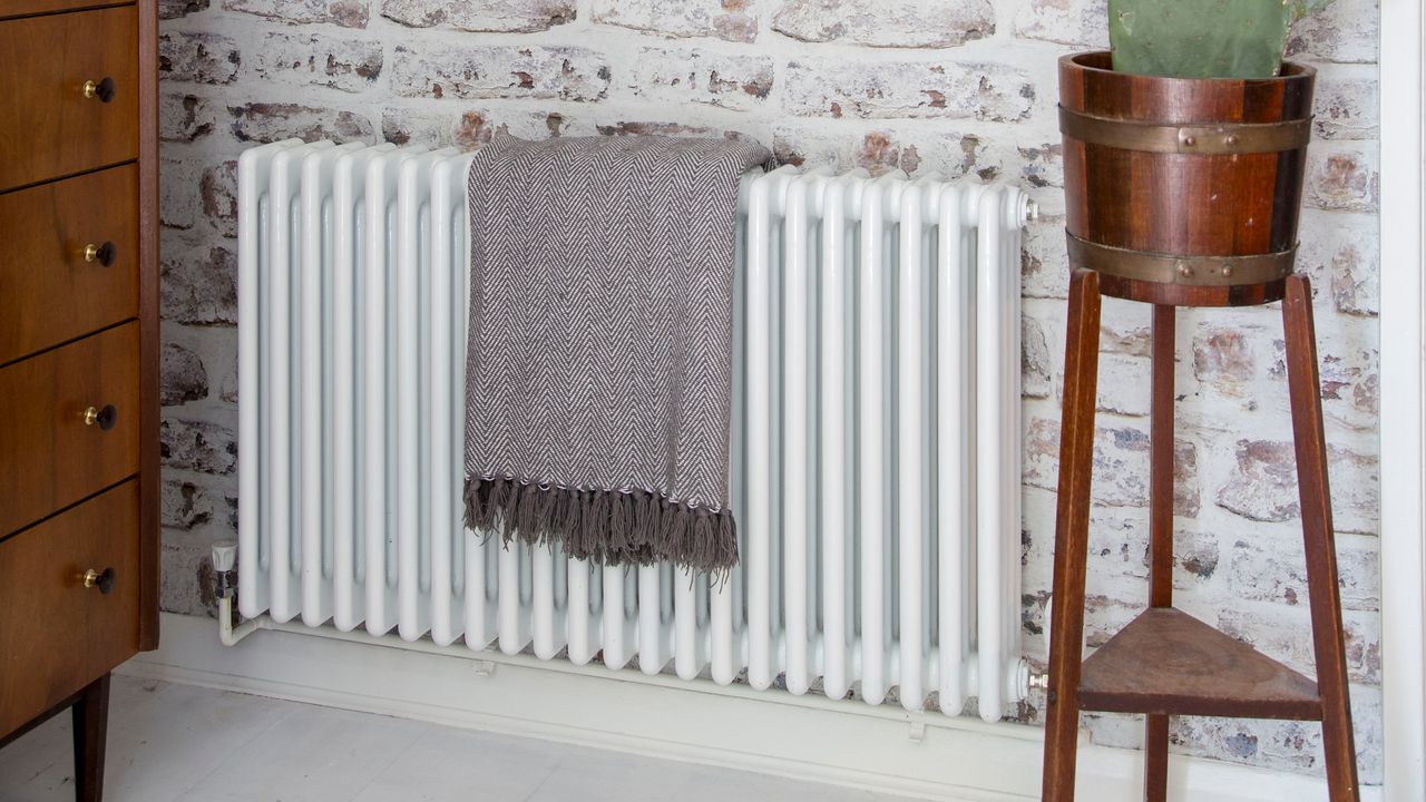 white radiator on white brick wall