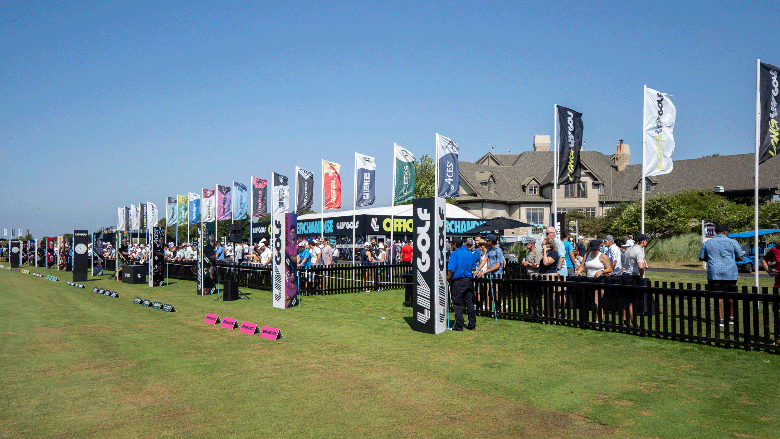 A general view of the driving range at LIV Golf Chicago with flags of all 13 teams flapping about behind the range