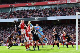 Leah Williamson of Arsenal heads the ball under pressure from Christiane Endler of Olympique Lyonnais during the UEFA Women's Champions League semifinal first leg match between Arsenal WFC and Olympique Lyonnais on April 19, 2025 in London, England.