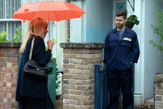 Sharon Watts holding a red umbrella tells Keanu Taylor some news outside his home.