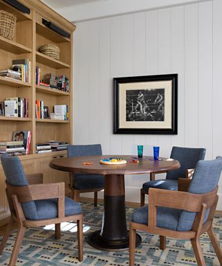 bookcase and round table with blue chairs