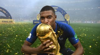 France's forward Kylian Mbappe kisses the World Cup trophy after the Russia 2018 World Cup final football match between France and Croatia at the Luzhniki Stadium in Moscow on July 15, 2018.