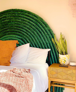 A green velvet arched headboard