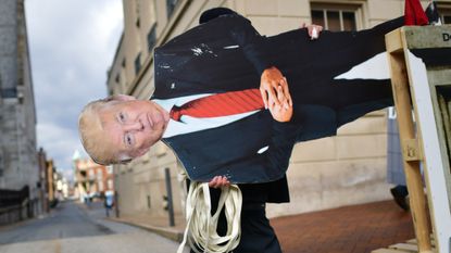 An effigy of Donald Trump is wheeled towards the Capitol ahead of the inauguration