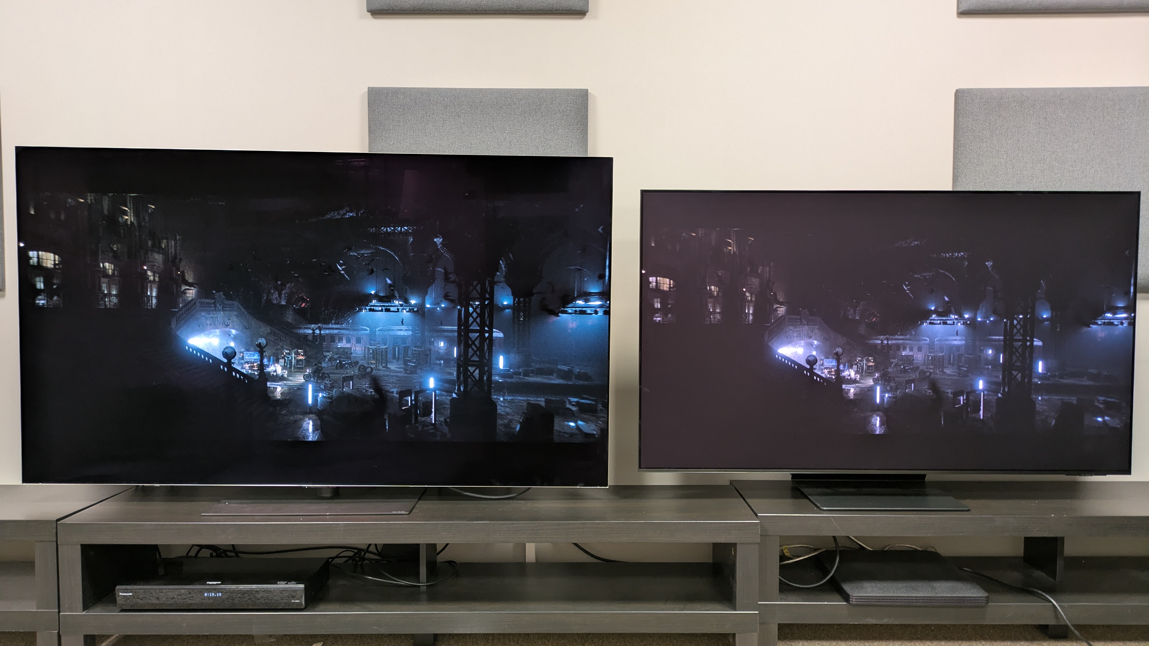 LG G6 (left) and Samsung S95F (right) showing an aerial view of the Batcave from The Batman, with deeper black tones visible on the LG TV