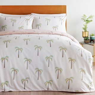 white bedroom with bed and palm tree beddings