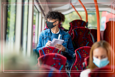 teenage boy wearing mask on bus