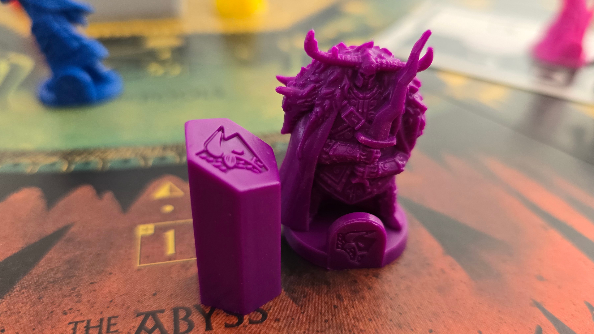 Veiled Fate miniature and token laid out on the board, with more visible in the background