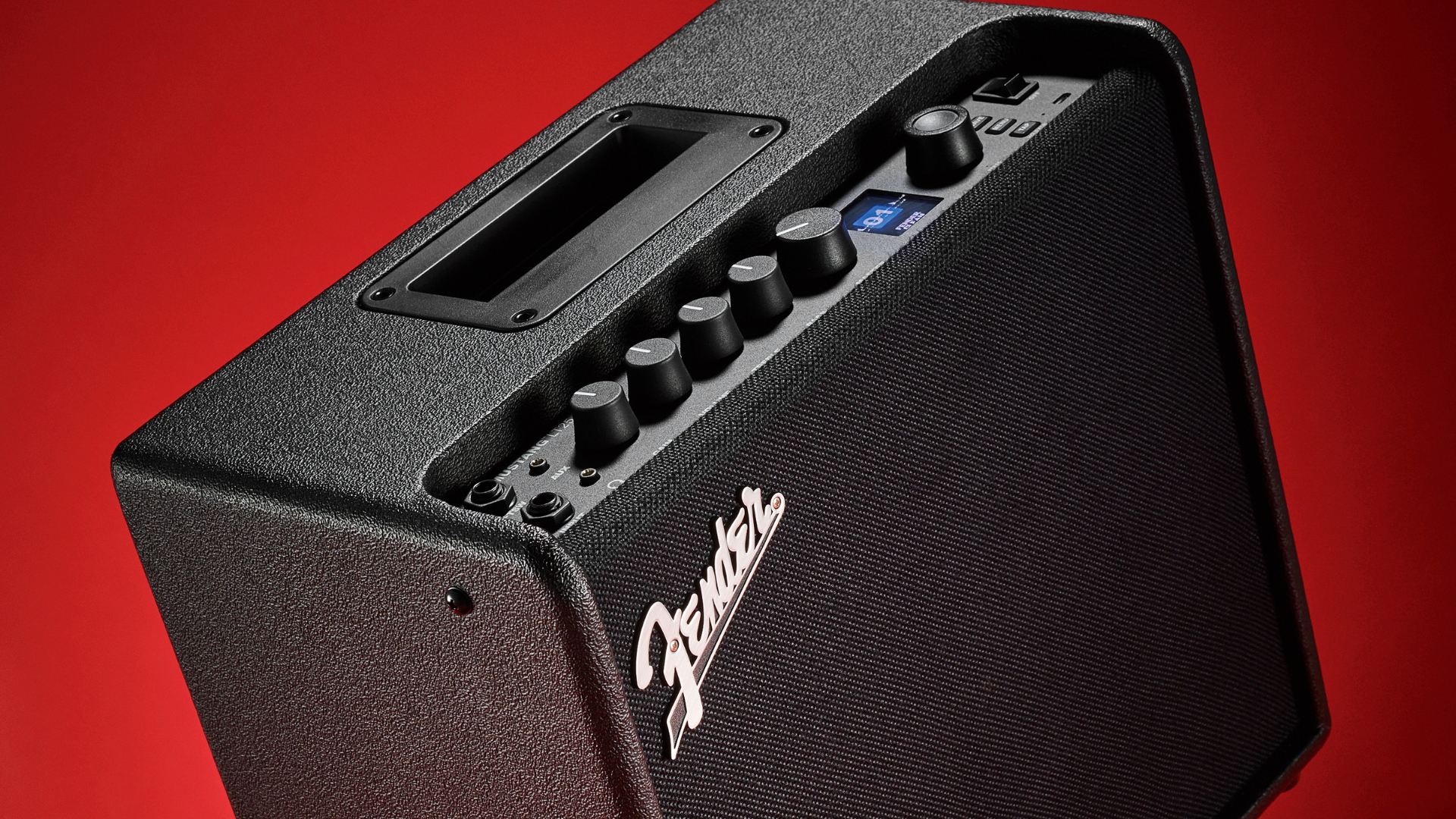 A Fender Mustang LT25 combo amp on a red background