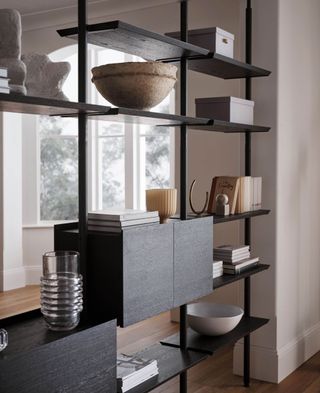 Modular shelving unit filled with sculptures and books