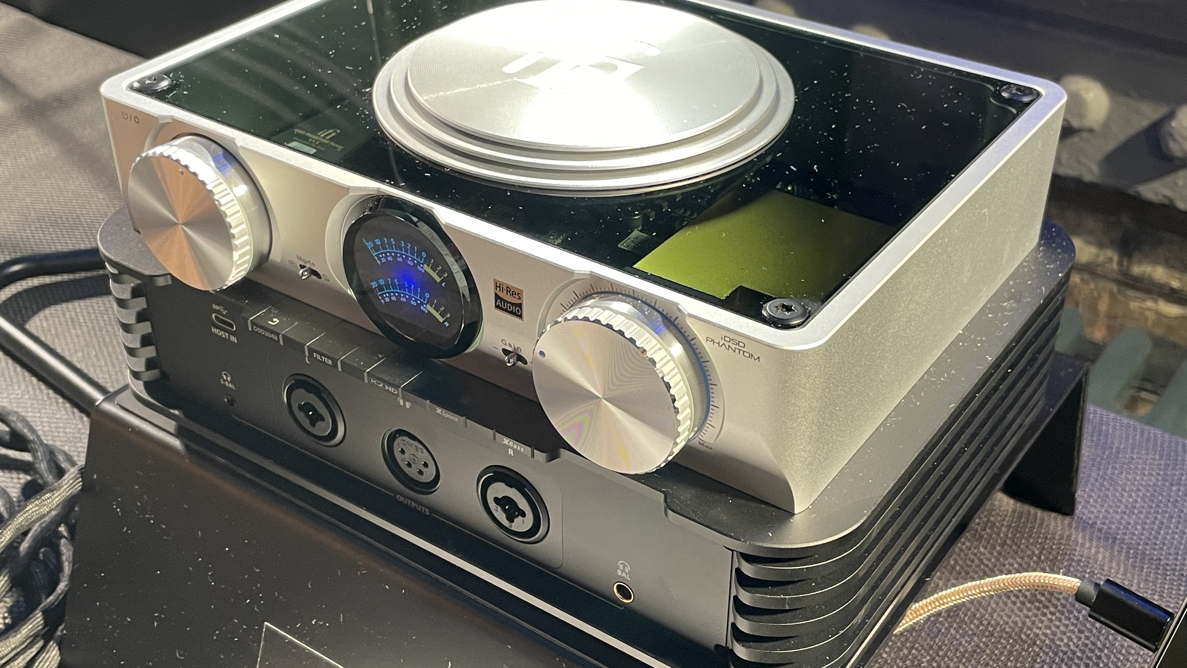 The formidable iFi iDSD Phantom in Tower Bridge, London, used with headphones and illuminating the front panel 