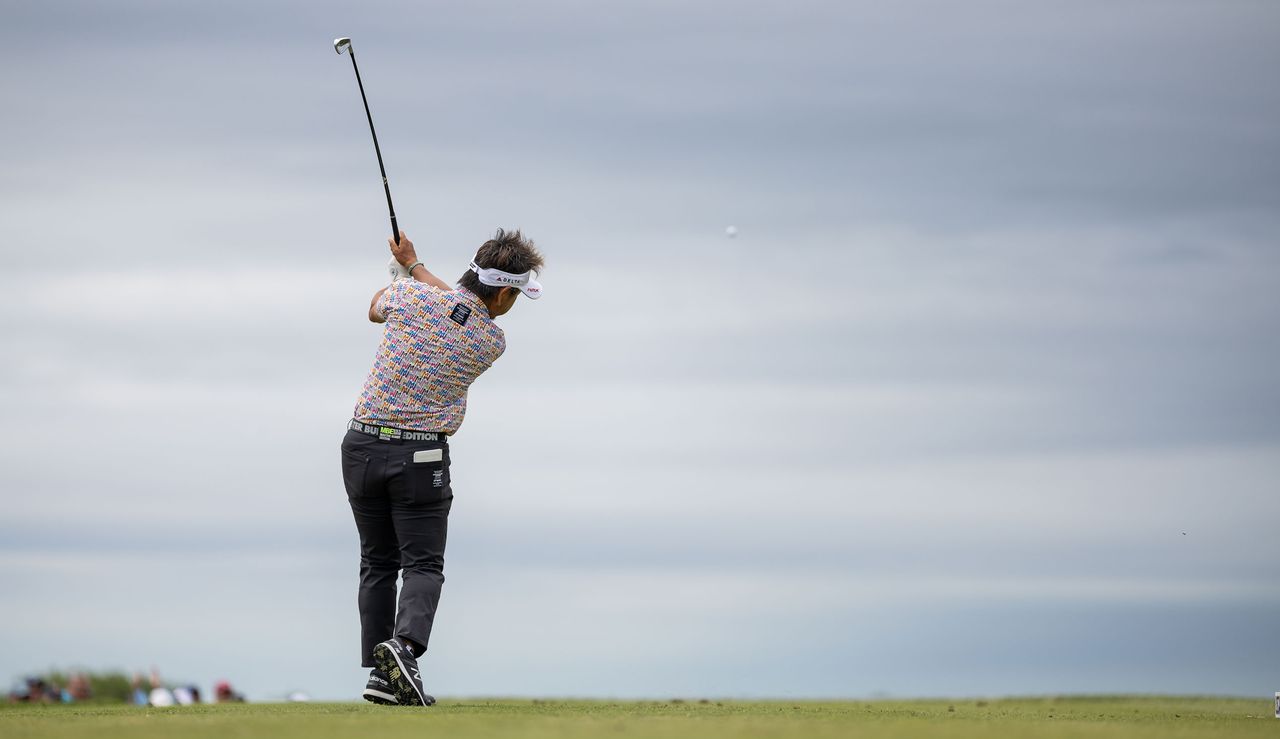 Hiroyuki Fujita strikes an iron shot from the middle of the fairway