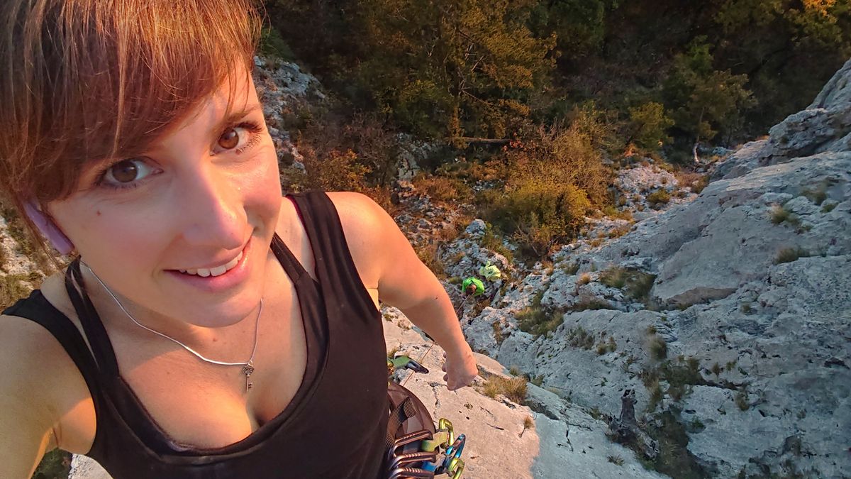 rock-climber wears a wireless earphone while climbing