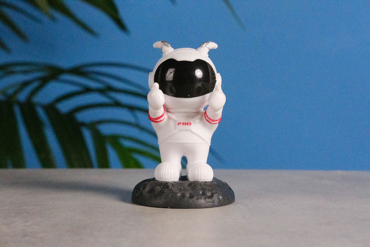 A photo of an astronaut toy against a blue background, taken on the Fujifilm X-E5