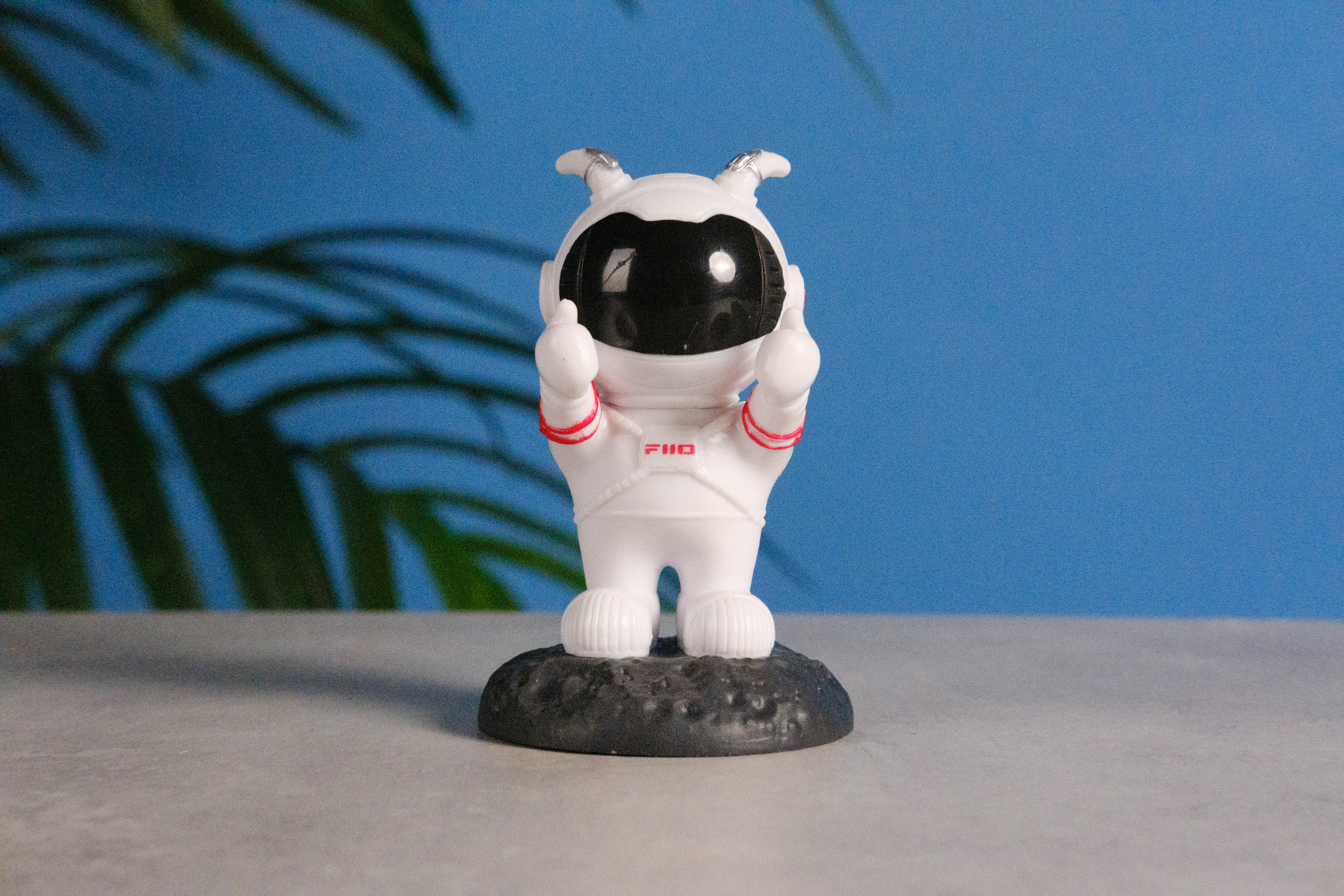 A photo of an astronaut toy against a blue background, taken on the Fujifilm X-E5