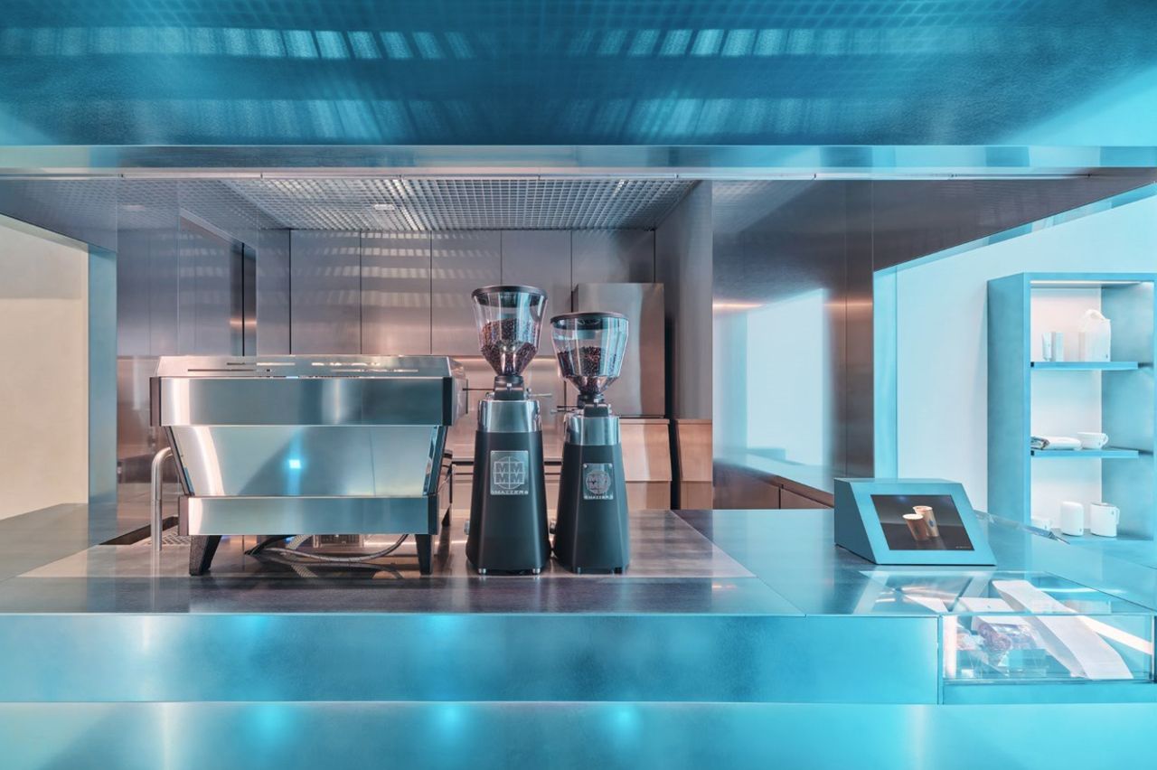 Blue-lit interior of Blue Bottle Coffee shop in Seoul, seen from the counter