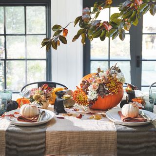 autumnal table with pumpkins and flowers